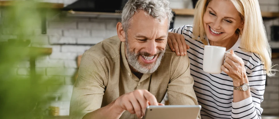 Couple in the kitchen drinking coffee and having a conversation