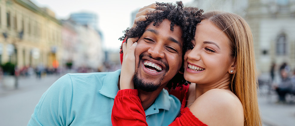 A couple embrace on a city street