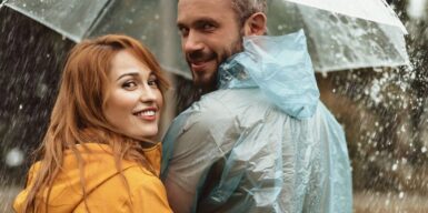 Couple caught in the rain under an umbrella together