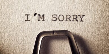 A piece of paper in a typewriter that says I'M SORRY