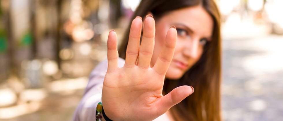 A woman putting her hand out as if to say stop