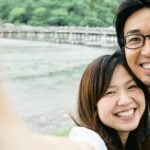 Japanese dating symbolized by a man and woman smiling into the camera