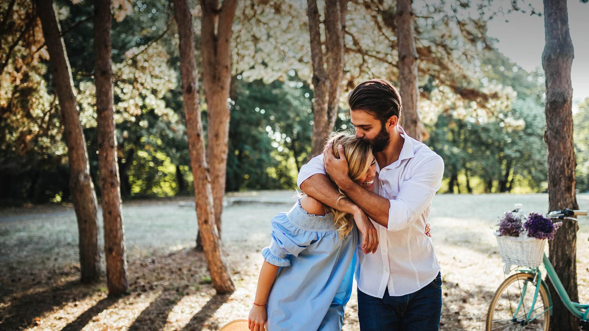 jewish dating symbolized by a man who embraces a woman and kisses on her head surounded by a forest in Australia