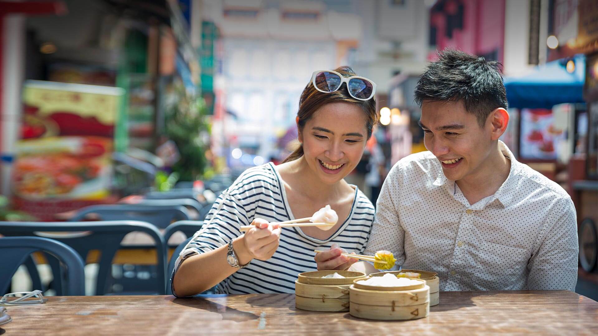 Thai Dating in Australia symbolized by a thai couple that enjoys food together