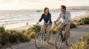 A couple riding bicycles along Glenelg Beach in Adelaide.