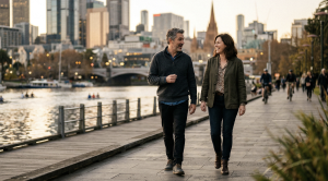 A couple walking next to the yarra river in melbourne on a date.
