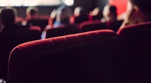 A row of Classic red movie theatre seats.