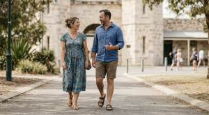A couple walking the fremantle prison on a sunny day.