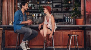 A couple sitting in a pub and chatting around.