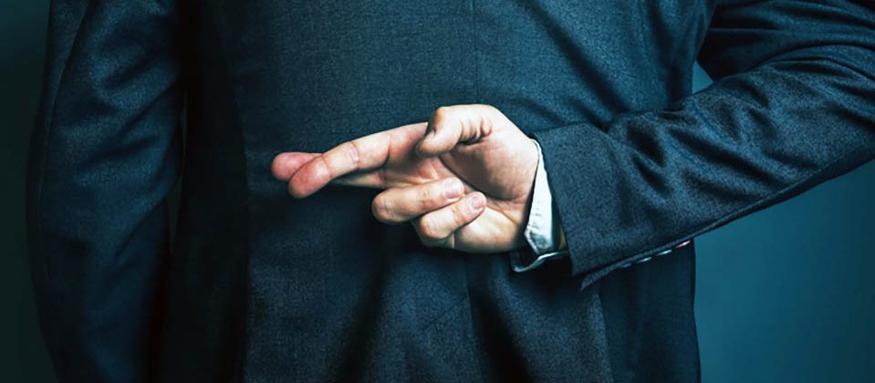Man with crossed fingers behind back