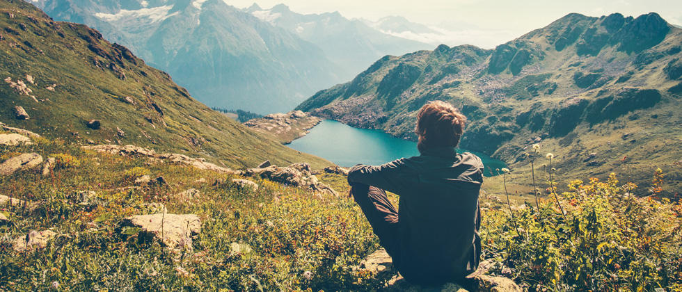 man sits alone on mountain as symbol of what to do when he pulls away