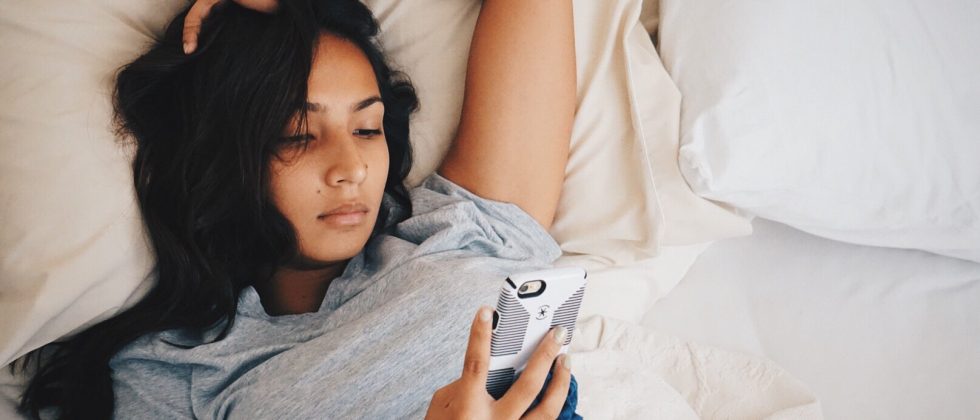how to get over a breakup symbolized by a woman lying thoughtful in her bed