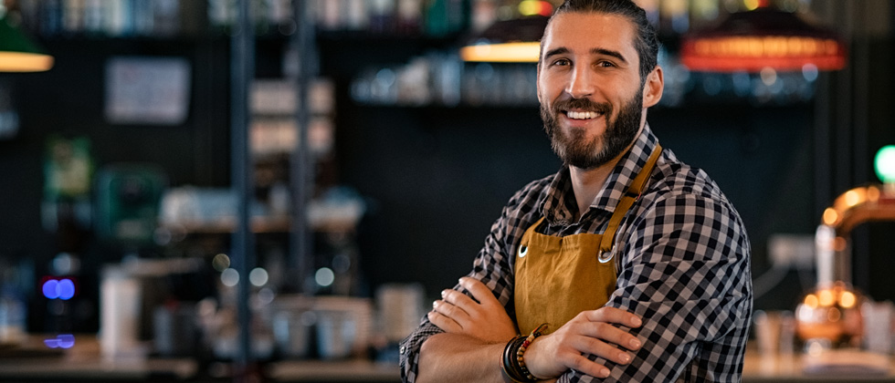Man standing and smiling to the camera as symbol for what to look for in a guy