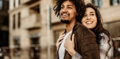 Woman hugging man from behind as a symbol of how to find the right person