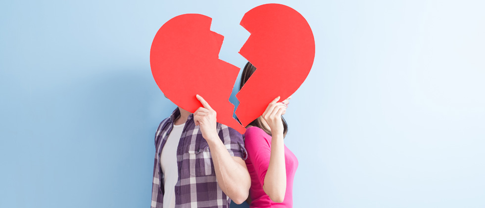 couple behind a broken heart not showing their faces