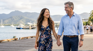 A couple strolling hand in hand at cairns trinity beach esplanade. (Generated with AI)