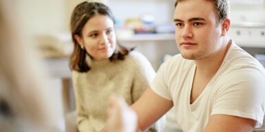 Man and woman sitting on the sofa as an example of questions to ask