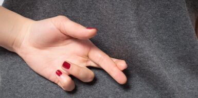 A woman crossing her fingers behind her back