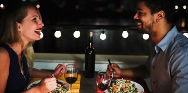 Man and woman have dinner together and laugh as a symbol for boyfriend material meaning