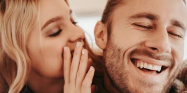 Woman whispers in man's ear as example of how to deal with mixed signals