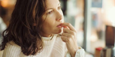 Woman looks thoughtful and wonders how to choose between two guys