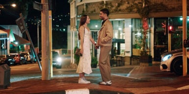 Man and woman standing holding hands on the street as a symbol of how to start dating