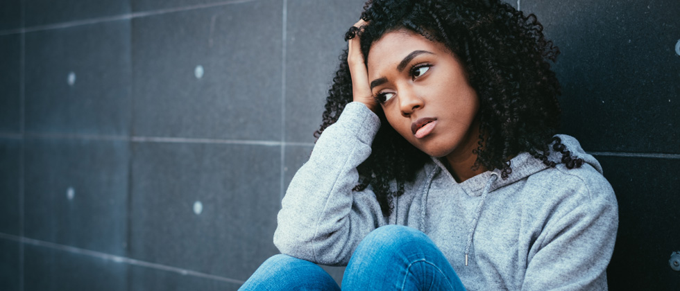 Woman sits and looks thoughtfully as example of sign when you should not marry him