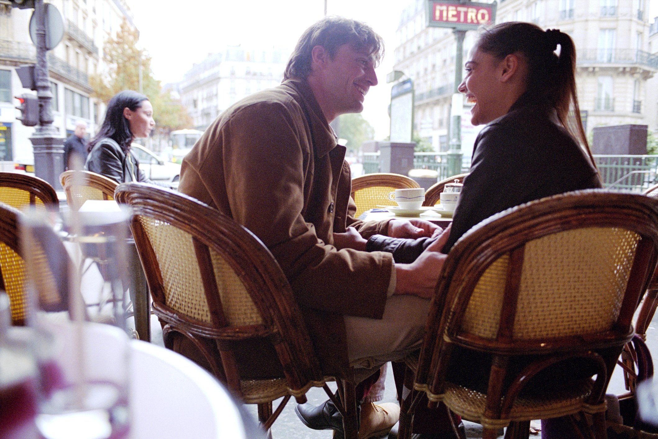 YOUNG MAN TOUCHING WOMANS ARM IN CAFE