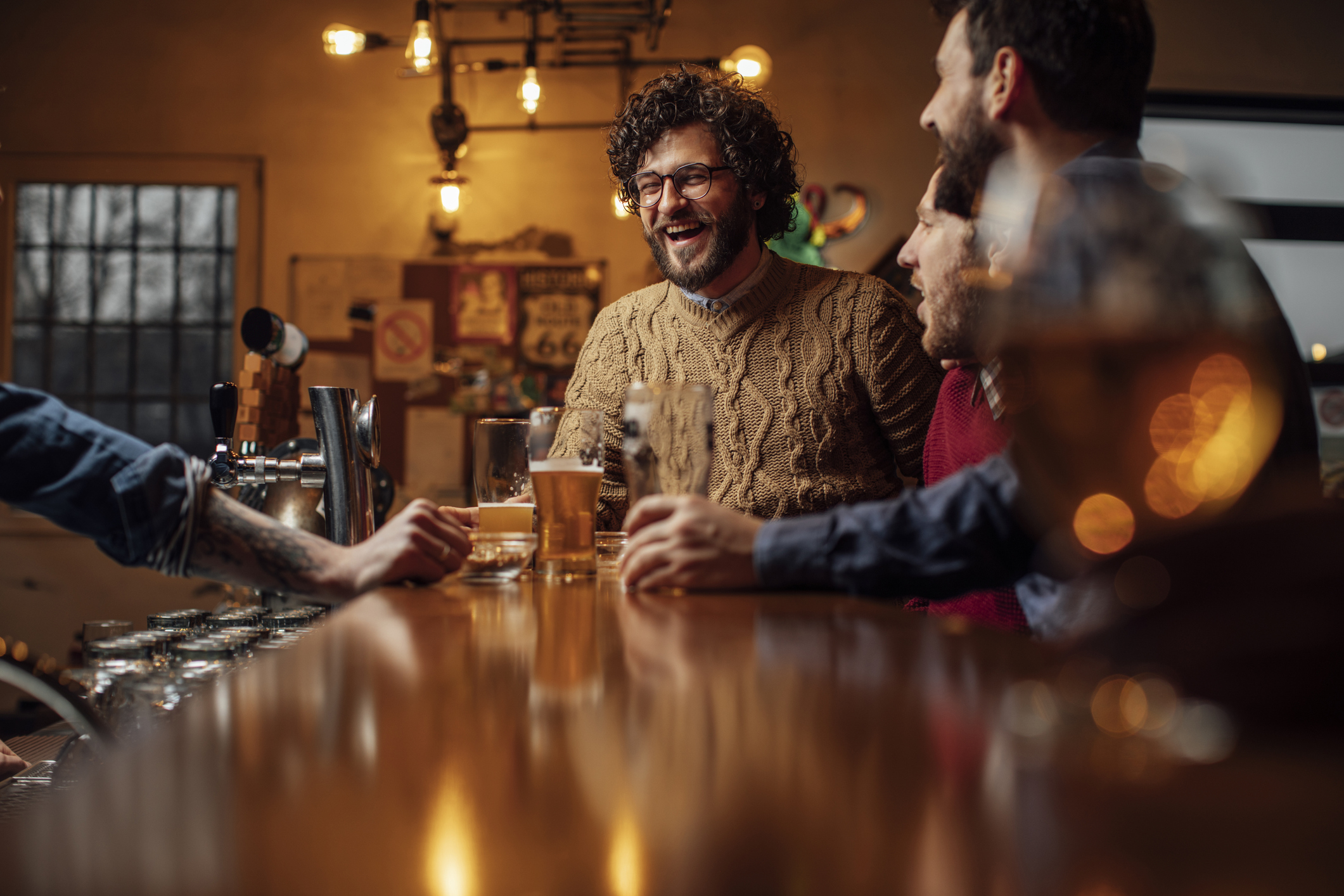 Group of Happy Men Drinking Beer at the Bar