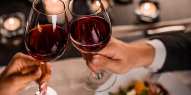 Couple on a dating cheering's with red wine