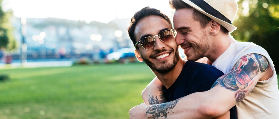 Two men lying in each other's arms as an example of a gay relationship