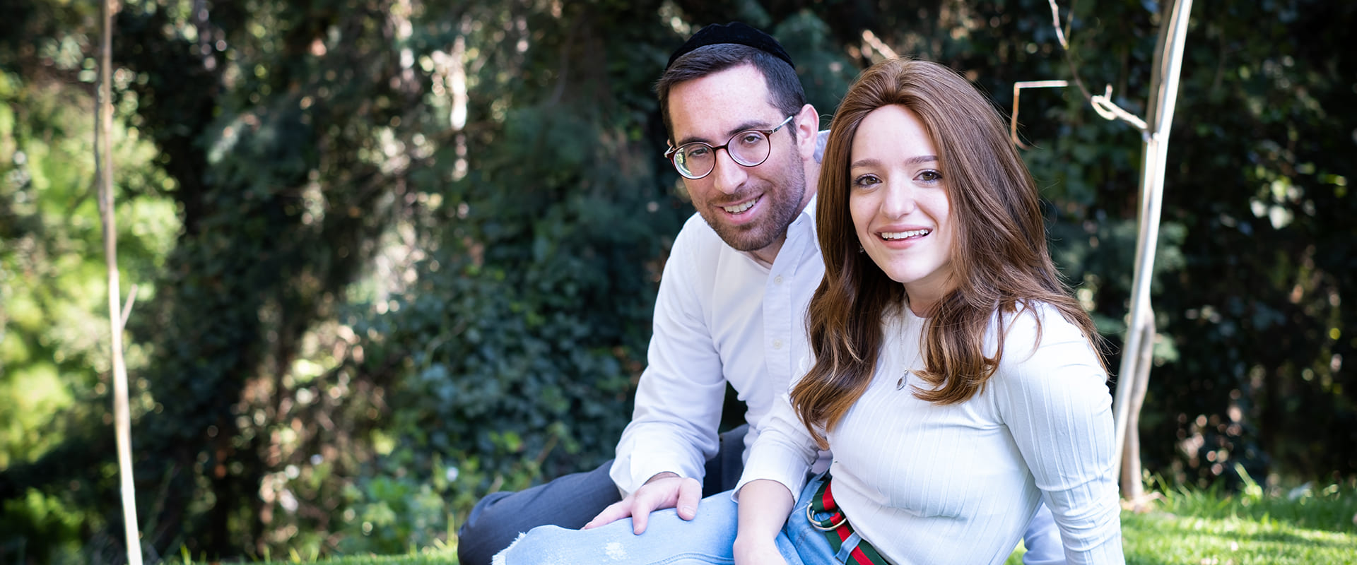 Jewish dating symbolized by a jewish men and woman sit side by side and look into the camera