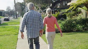 A couple strolling through a neighborhood. (Generated with AI)