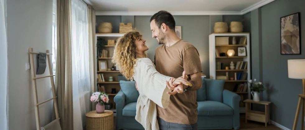 Couple dancing in their living room