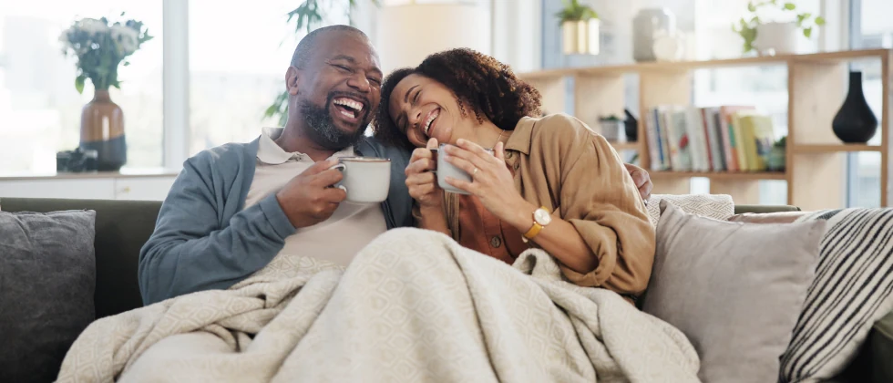 Couple on the couch laughing and having a good time