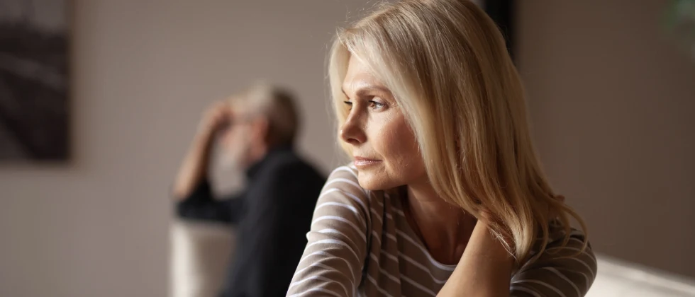A couple who just broke up. She's slowing turning around to her ex partner in the background.
