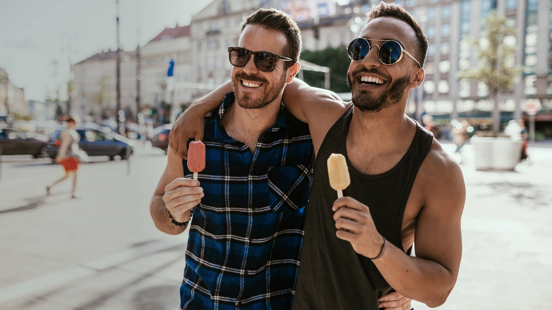 A gay couple enjoying ice cream in the streets of sydney at summer.